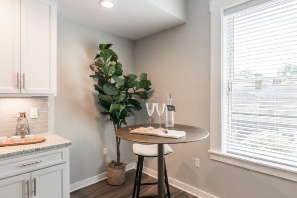 Photo Of A Corner In Harpeth Square Apartment Amenities, It Has Two Glasses, A A Water Vase, And A Plant On The Corner.